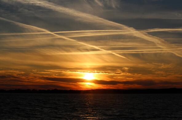 Sunset with jet contrails