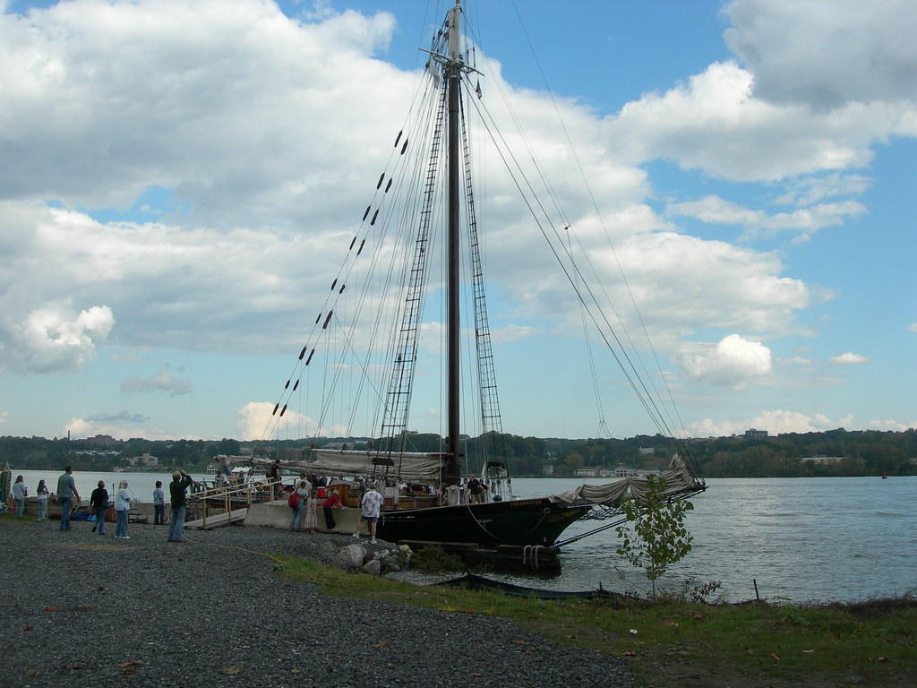 Image description: Sloop Clearwater docked on shore with visitors.