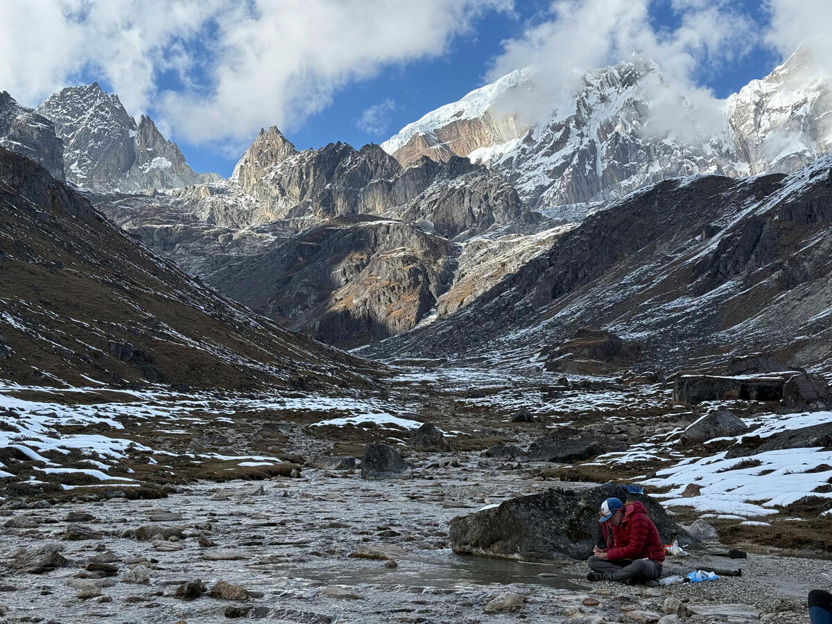 Maavara collecting water samples from a stream